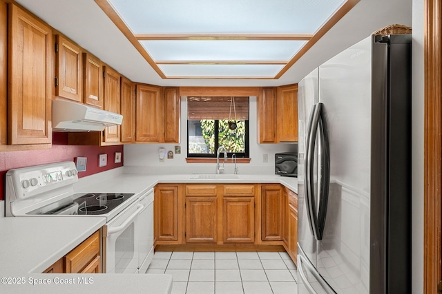 1875 Halifax Ave, Melbourne, FL 32935 - kitchen with white appliances, under cabinet range hood, a sink, light tile patterned flooring, and light countertops