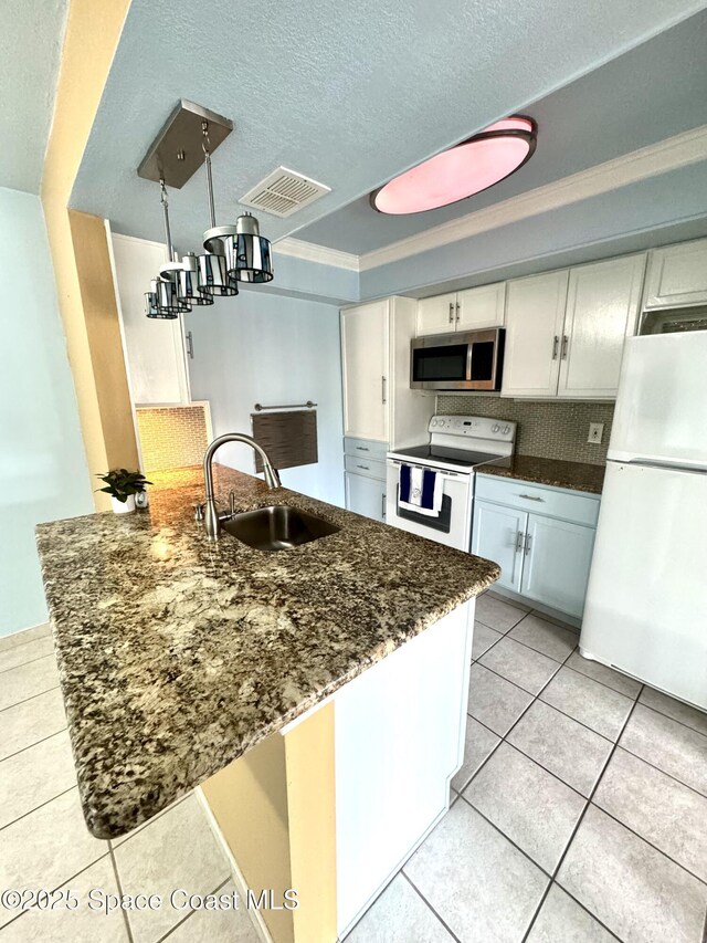 624 Ridge Club Dr Unit 86, Melbourne, FL 32934 - kitchen featuring white appliances, a sink, white cabinets, light tile patterned flooring, and a raised ceiling