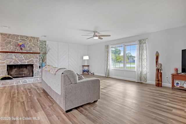 living room with ceiling fan, wood finished floors, and baseboards