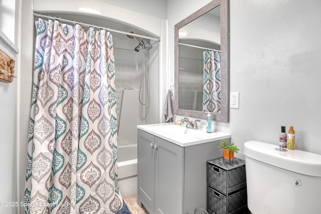 bathroom with toilet, vanity, and shower / bathtub combination with curtain