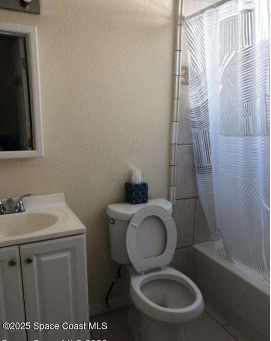 full bathroom with toilet, vanity, tile patterned floors, and shower / bath combination with curtain