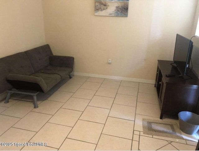 living area with light tile patterned floors and baseboards