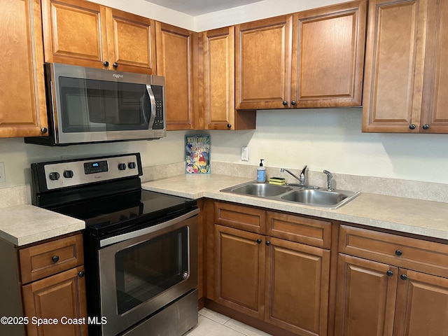 406 Tyler Ave Unit 4, Cape Canaveral, FL 32920 - kitchen featuring appliances with stainless steel finishes, brown cabinets, and light countertops