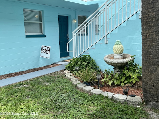 406 Tyler Ave Unit 4, Cape Canaveral, FL 32920 - entrance to property featuring concrete block siding and a yard