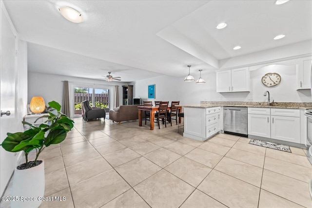 kitchen featuring dishwasher, white cabinets, light tile patterned floors, light stone counters, and recessed lighting