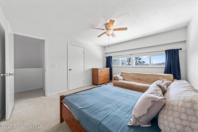 bedroom featuring carpet, ceiling fan, a textured ceiling, and baseboards