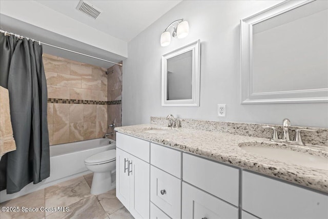 bathroom with toilet, double vanity, and shower / tub combo