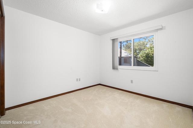 9020 Brighton Ct Unit 4-H, West Melbourne, FL 32904 - spare room with carpet flooring, baseboards, and a textured ceiling