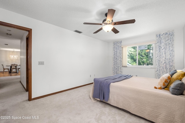 9020 Brighton Ct Unit 4-H, West Melbourne, FL 32904 - bedroom with light carpet, a chandelier, baseboards, and a ceiling fan