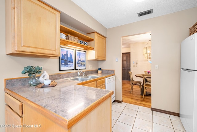 9020 Brighton Ct Unit 4-H, West Melbourne, FL 32904 - kitchen featuring white appliances, light brown cabinetry, a sink, tile countertops, and a textured ceiling
