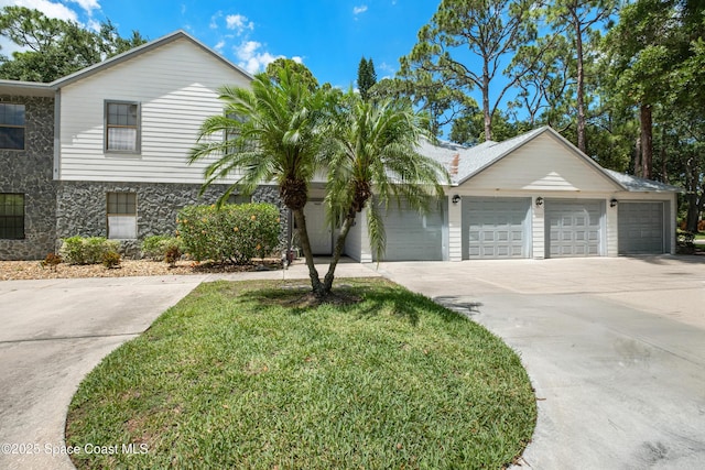 9020 Brighton Ct Unit 4-H, West Melbourne, FL 32904 - view of front of home featuring concrete driveway, an attached garage, stone siding, and a front yard