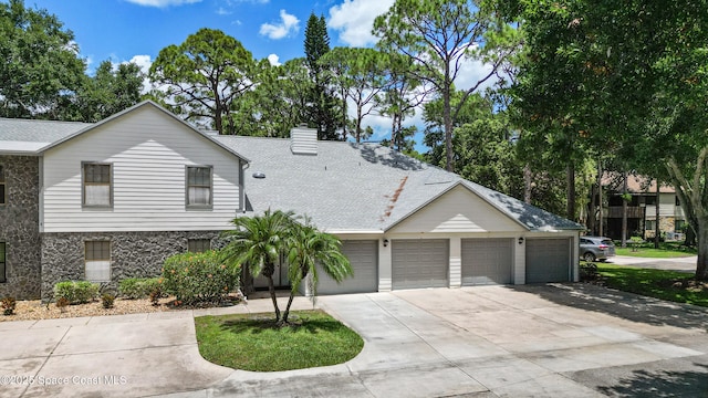 9020 Brighton Ct Unit 4-H, West Melbourne, FL 32904 - view of front of home with concrete driveway, a shingled roof, a garage, and a chimney