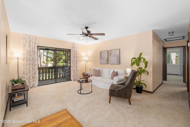 9020 Brighton Ct Unit 4-H, West Melbourne, FL 32904 - carpeted living room with ceiling fan, a textured ceiling, and baseboards