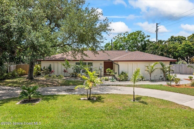 515 Hibiscus Trl, Melbourne Beach, FL 32951 - view of front facade featuring curved driveway and stucco siding