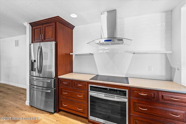 515 Hibiscus Trl, Melbourne Beach, FL 32951 - kitchen with appliances with stainless steel finishes, extractor fan, light wood-type flooring, light stone countertops, and ornamental molding