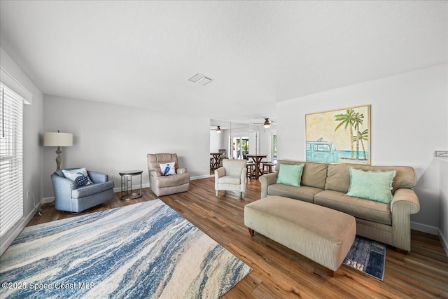 515 Hibiscus Trl, Melbourne Beach, FL 32951 - living area with a ceiling fan, baseboards, and wood finished floors