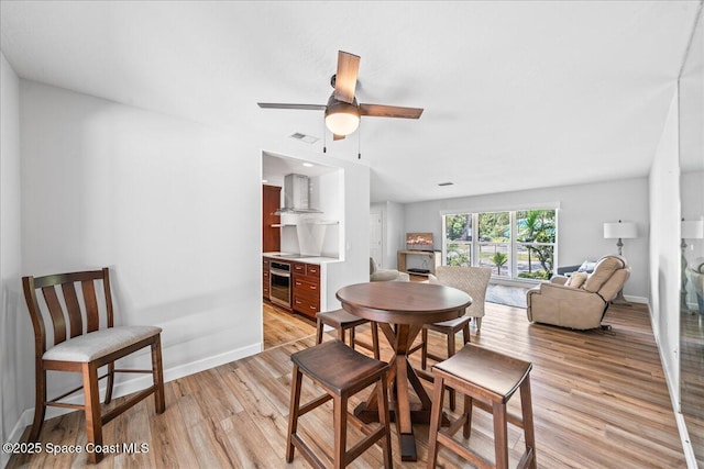 515 Hibiscus Trl, Melbourne Beach, FL 32951 - dining room featuring light wood-style flooring, baseboards, and a ceiling fan