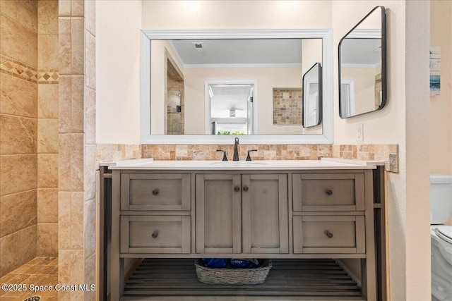 515 Hibiscus Trl, Melbourne Beach, FL 32951 - full bath featuring vanity, toilet, tiled shower, ornamental molding, and wainscoting