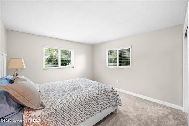 515 Hibiscus Trl, Melbourne Beach, FL 32951 - carpeted bedroom featuring multiple windows, baseboards, and a textured ceiling