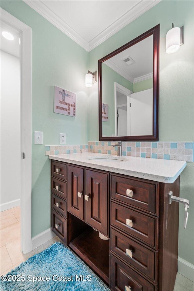515 Hibiscus Trl, Melbourne Beach, FL 32951 - bathroom featuring baseboards, vanity, tile patterned flooring, crown molding, and decorative backsplash