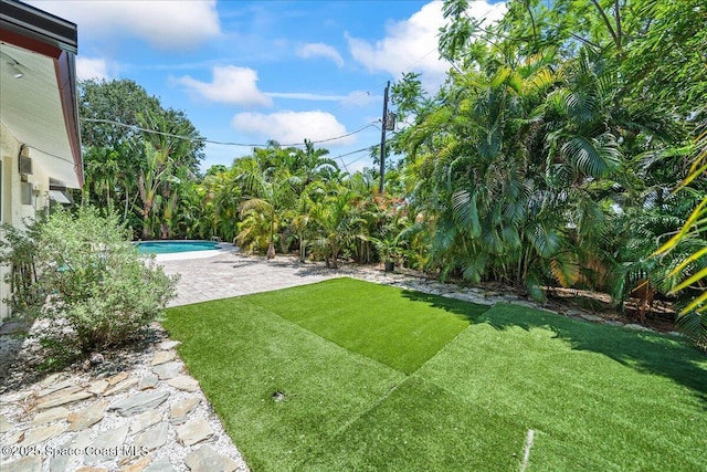 515 Hibiscus Trl, Melbourne Beach, FL 32951 - view of green lawn featuring a patio and an outdoor pool