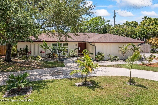 515 Hibiscus Trl, Melbourne Beach, FL 32951 - view of front facade with driveway and stucco siding