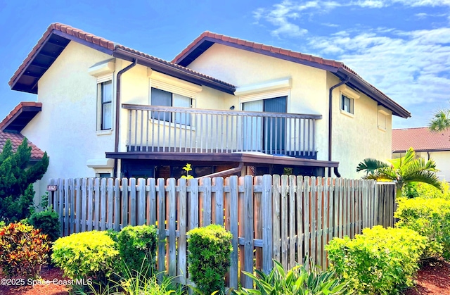 3362 Sandy Reef Ct, Melbourne Beach, FL 32951 - view of front of property with a balcony, stucco siding, and a tile roof