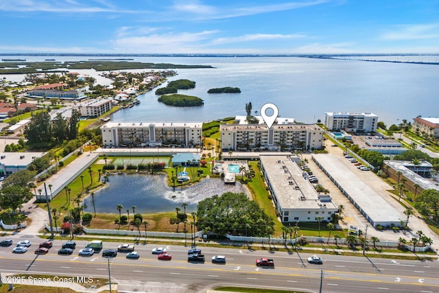 aerial view of apartment complex / building and a nearby body of water