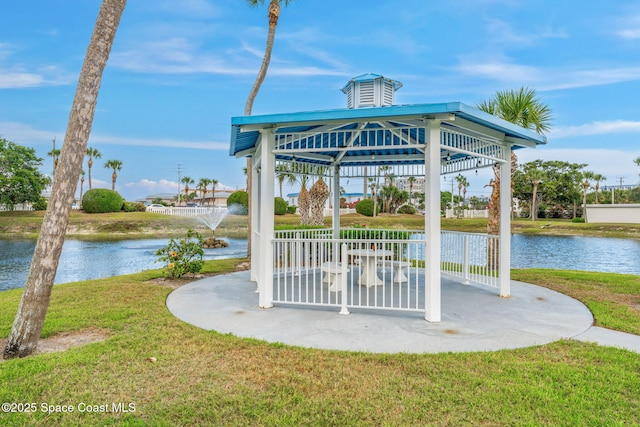 view of home's community with a lawn, a gazebo, and a water view