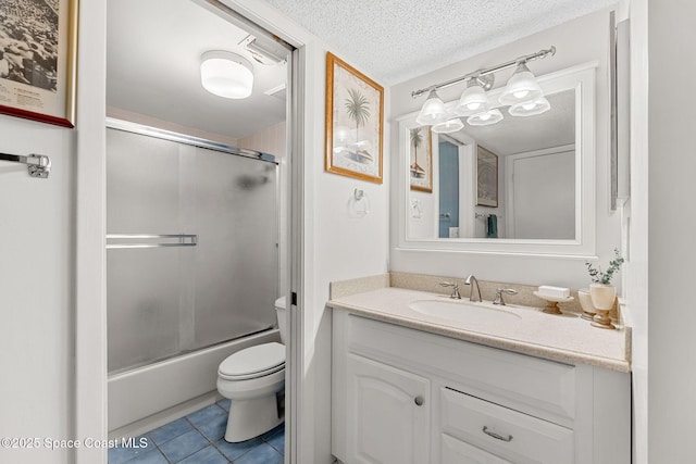 full bathroom featuring vanity, tile patterned flooring, toilet, bath / shower combo with glass door, and a textured ceiling