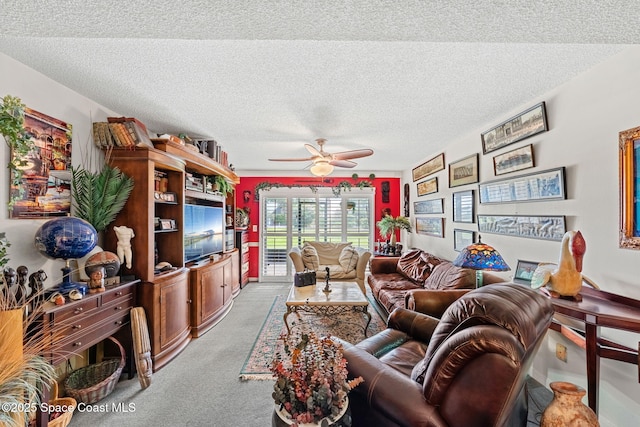 living area featuring light carpet, a textured ceiling, and a ceiling fan