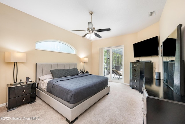 bedroom featuring access to exterior, light colored carpet, baseboards, and ceiling fan