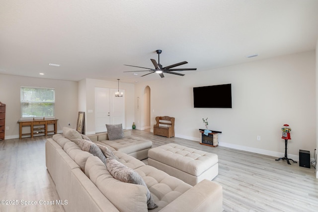2602 Flintstone Ave SE, Palm Bay, FL 32909 - living room with arched walkways, light wood finished floors, baseboards, recessed lighting, and a ceiling fan