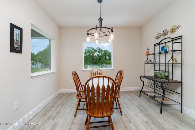 2602 Flintstone Ave SE, Palm Bay, FL 32909 - dining room with light wood finished floors, plenty of natural light, a chandelier, and baseboards