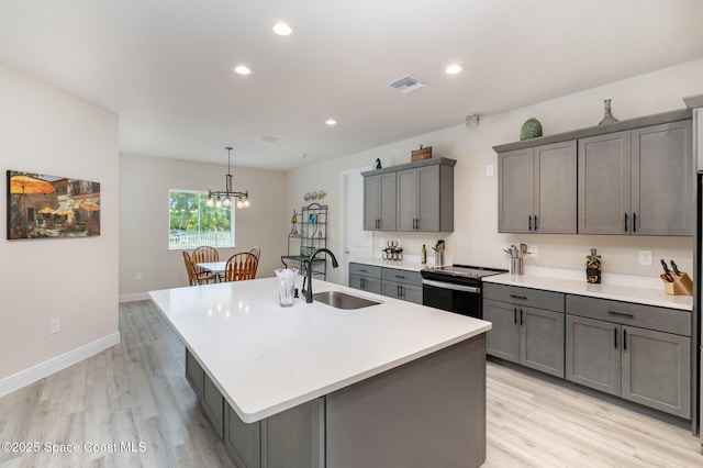 2602 Flintstone Ave SE, Palm Bay, FL 32909 - kitchen featuring a sink, black range with electric stovetop, light wood finished floors, gray cabinetry, and recessed lighting