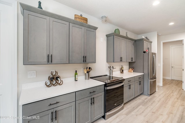 2602 Flintstone Ave SE, Palm Bay, FL 32909 - kitchen with stainless steel appliances, gray cabinets, recessed lighting, light wood-type flooring, and light countertops
