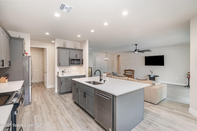 2602 Flintstone Ave SE, Palm Bay, FL 32909 - kitchen with gray cabinetry, a sink, stainless steel appliances, baseboards, and recessed lighting