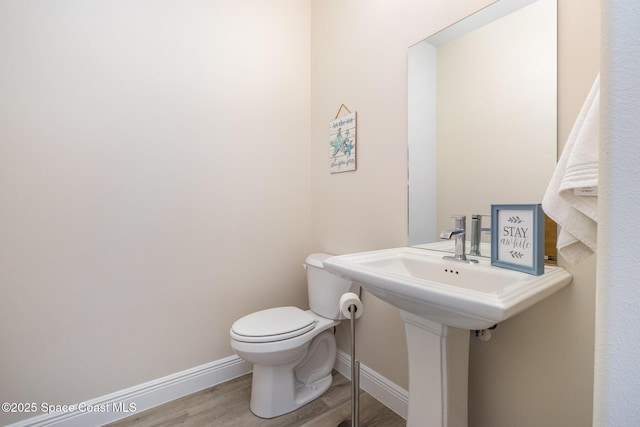 2602 Flintstone Ave SE, Palm Bay, FL 32909 - half bath with wood finished floors, baseboards, and toilet