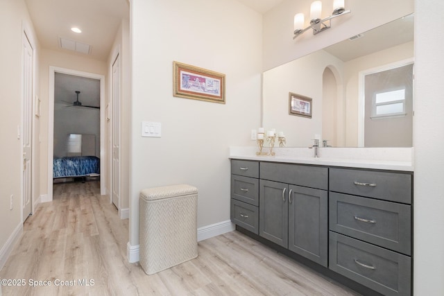 2602 Flintstone Ave SE, Palm Bay, FL 32909 - bathroom featuring wood finished floors, vanity, baseboards, a ceiling fan, and recessed lighting