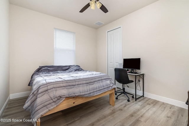 2602 Flintstone Ave SE, Palm Bay, FL 32909 - bedroom with wood finished floors, baseboards, a closet, and a ceiling fan