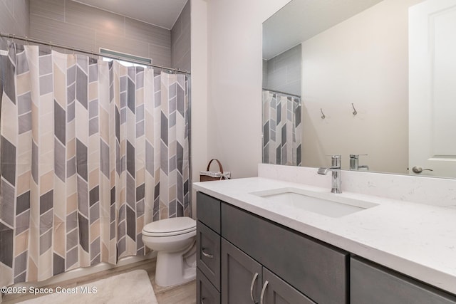 2602 Flintstone Ave SE, Palm Bay, FL 32909 - full bath featuring toilet, vanity, wood finished floors, and a shower with curtain