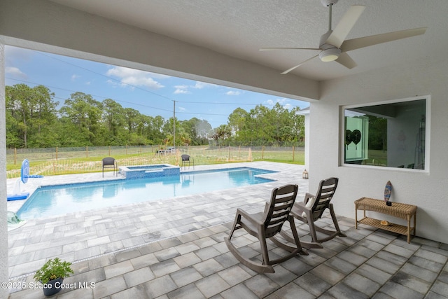 2602 Flintstone Ave SE, Palm Bay, FL 32909 - view of pool with a patio area, ceiling fan, a fenced backyard, view of scattered trees, and a pool with connected hot tub