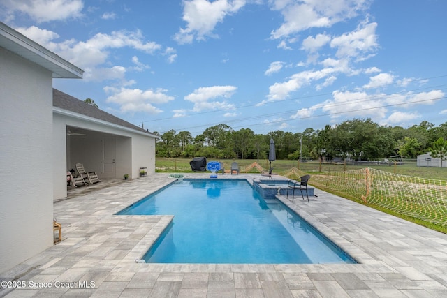 2602 Flintstone Ave SE, Palm Bay, FL 32909 - view of swimming pool with a patio, a pool with connected hot tub, and view of scattered trees