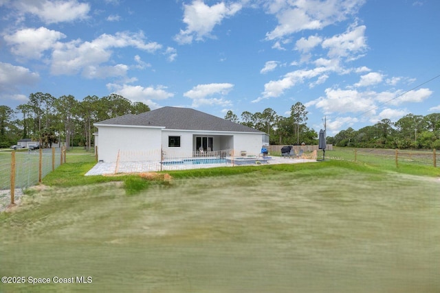 2602 Flintstone Ave SE, Palm Bay, FL 32909 - back of house featuring a patio area, stucco siding, and a fenced backyard