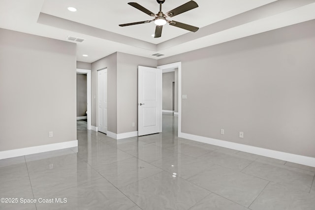 926 Sareta St SE, Palm Bay, FL 32909 - unfurnished room featuring a ceiling fan, baseboards, a tray ceiling, and recessed lighting