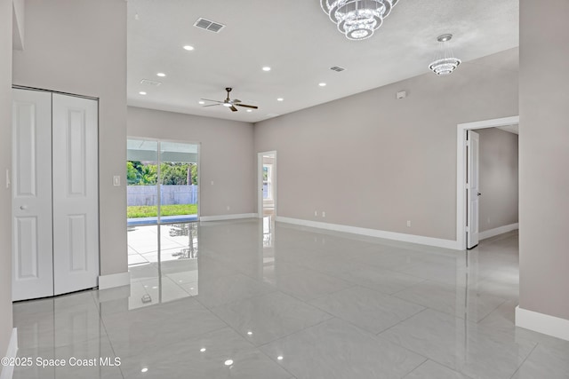 926 Sareta St SE, Palm Bay, FL 32909 - spare room with baseboards, a ceiling fan, recessed lighting, a chandelier, and light tile patterned floors