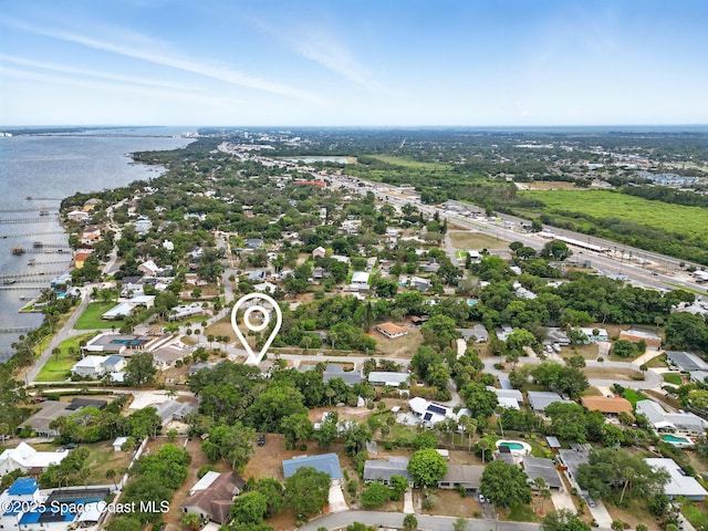 aerial view of residential area featuring a large body of water