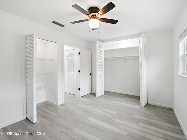 unfurnished bedroom featuring wood finished floors, baseboards, and a ceiling fan