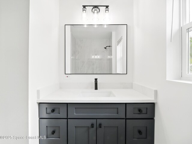 bathroom with vanity and a shower