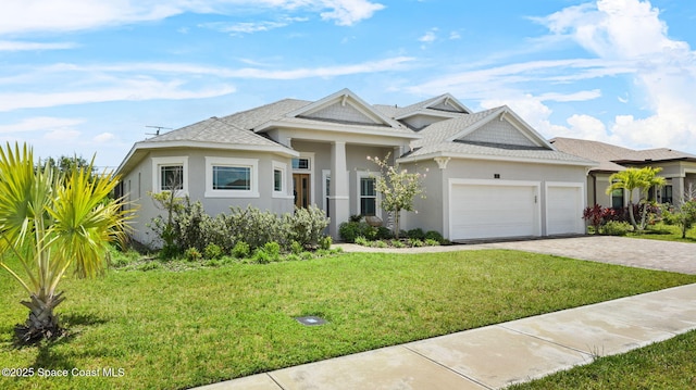 2737 Kilns Cir, West Melbourne, FL 32904 - view of front of house featuring stucco siding, a garage, decorative driveway, a front lawn, and roof with shingles